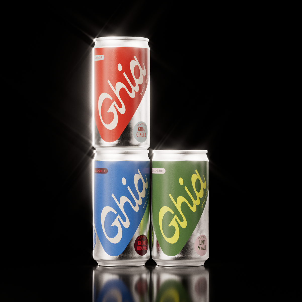 Three Ghia non-alcoholic spritz cans in red, blue, and green, featuring Ginger, Blood Orange, and Lime & Salt flavors, stacked against a black background.