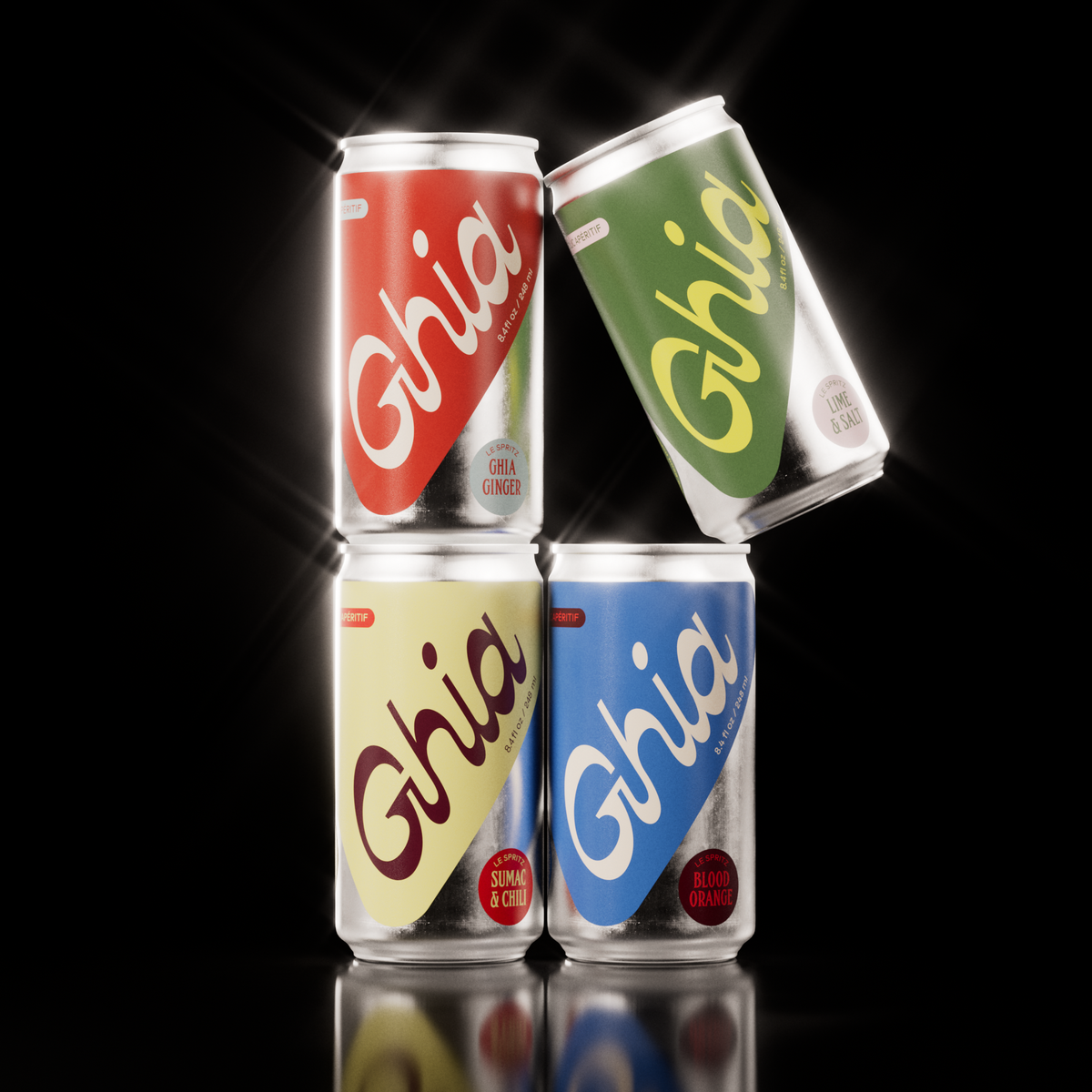 Four Ghia non-alcoholic spritz cans in red, green, yellow, and blue, featuring Ghia Ginger, Lime & Salt, Sumac & Chili, and Blood Orange flavors, stacked against a black background.