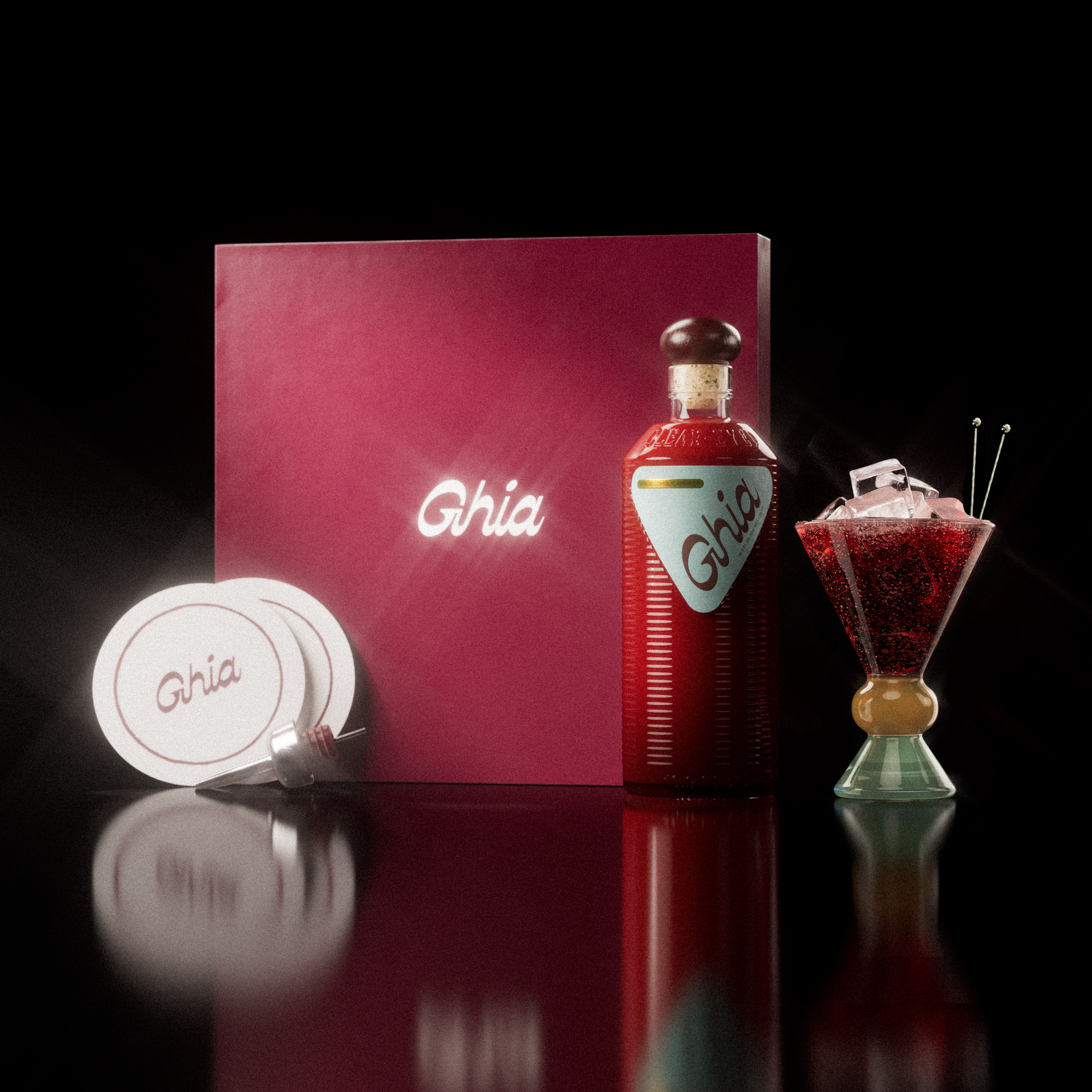 A Ghia non-alcoholic aperitif gift set with a burgundy box, paper coasters, 1 glass bottle of Original Apéritif, and a decorative cocktail glass that has a sand and jade base.